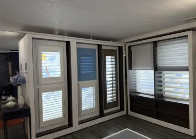 Window treatment showroom displaying shutters and blinds styles for home decor.